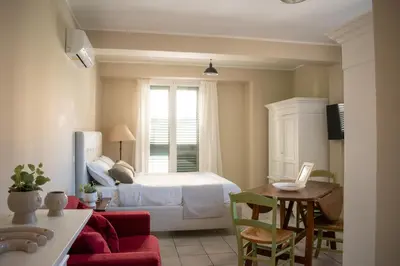 a bedroom with a bed and a table and chairs at Le Case del Massimo in centrocittà in Palermo
