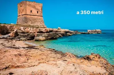 a lighthouse sitting on the edge of the ocean at Villa Emma 50 mt from the sea with private pool in Carini