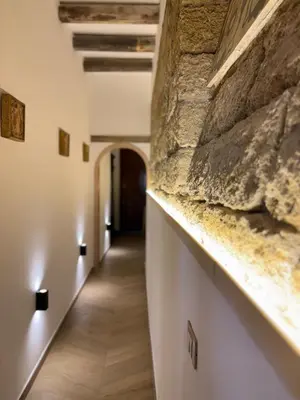 a hallway of a building with a stone wall at Palermo Sunset in Palermo
