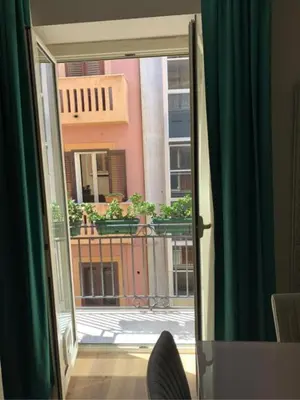 a sliding glass door with a view of a building at Sperlinga Suite in Palermo
