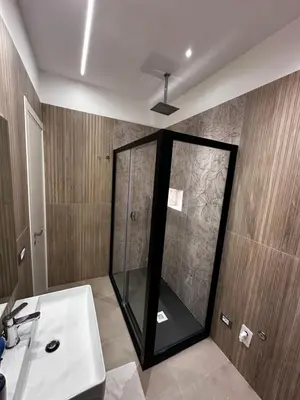 a bathroom with a glass shower and a sink at La Casetta di Sa Lu in Capaci