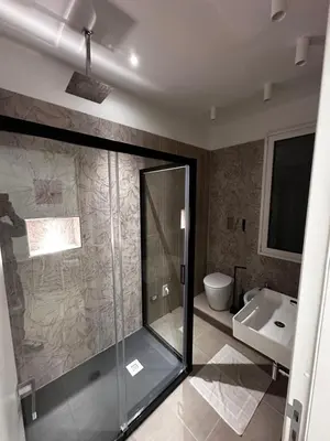 a bathroom with a glass shower and a sink at La Casetta di Sa Lu in Capaci