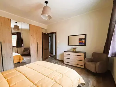 a bedroom with a bed and a chair in it at Gira e Firria in Palermo
