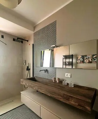 a bathroom with a wooden bench and a mirror at Gira e Firria in Palermo