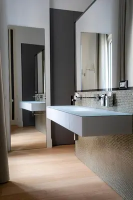 a bathroom with two sinks and a large mirror at G Cave 125 Boutique Apartment in Palermo