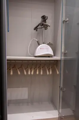 a walk in shower with a phone on a shelf at G Cave 125 Boutique Apartment in Palermo