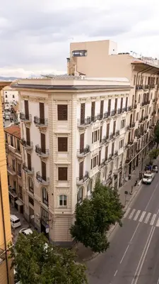 a large white building on a city street at G Cave 125 Boutique Apartment in Palermo