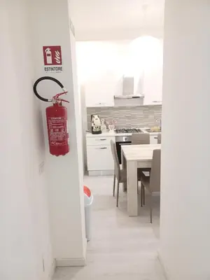 a kitchen with a fire extinguisher hanging on the wall at La casa di gabry in Palermo