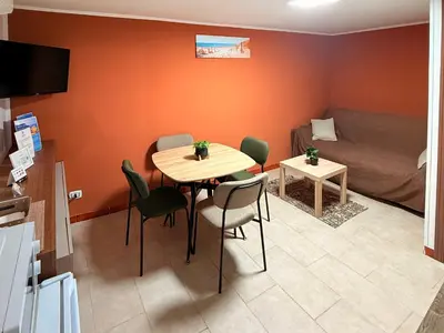 a living room with a table and chairs and a couch at Dimora del Moro alla Cattedrale in Palermo