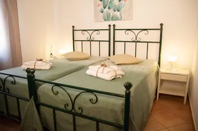 a bed with two folded towels on top of it at Anemos Apartment - Villa Luna in Macari