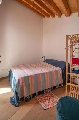 a bedroom with a bed with a striped blanket at Summaq Terrace in Palermo