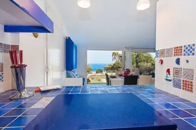 a room with a blue tiled floor with a swimming pool at Villa Pandora in Scopello