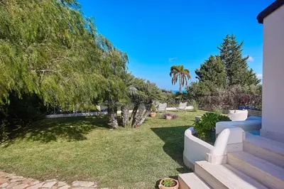a backyard with trees and a lawn with stairs at Villa Pandora in Scopello