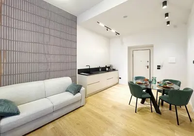 a living room with a white couch and a table at Solemar Sicilia - Design Apartment Palermo in Palermo