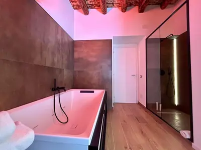 a bathroom with a pink tub and a shower at Paternostro Luxury Apartment in Palermo