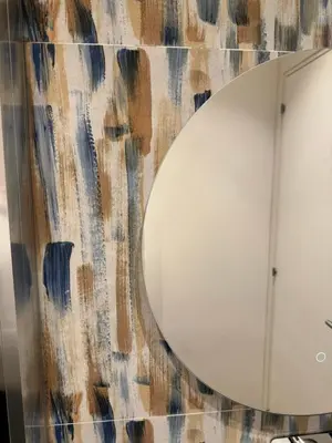 a mirror on a wall next to a bathroom at Paternostro Luxury Apartment in Palermo