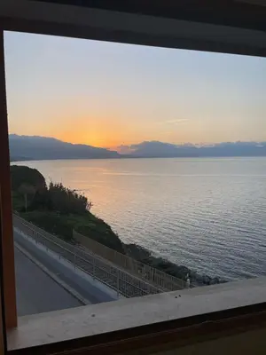 a view of the ocean at sunset from a window at Finestra sul golfo in Balestrate