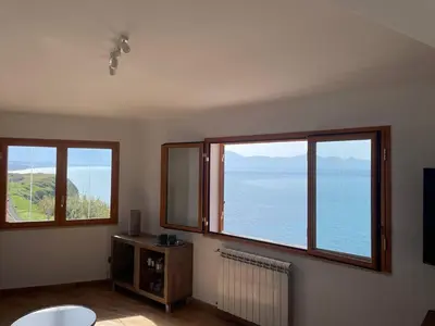 a room with three windows and a view of the ocean at Finestra sul golfo in Balestrate