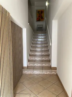 a staircase in a building with a tile floor at Finestra sul golfo in Balestrate