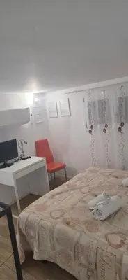 a bedroom with a bed and a desk and two chairs at Tourist House Palermo in Palermo