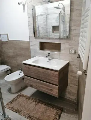 a bathroom with a sink and a toilet and a mirror at Tourist House Palermo in Palermo