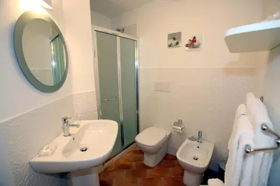 a bathroom with a sink and a toilet and a mirror at B&B Teatro in Palermo