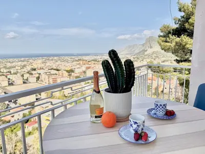 a table with a bottle of wine and a cactus at The Best View Sicily Apart in Carini