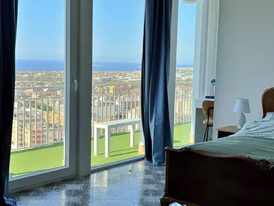 a bedroom with a bed and a view of a city at The Best View Sicily Apart in Carini