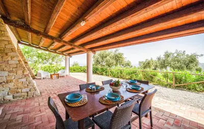 an outdoor patio with a wooden table and chairs at Nice Apartment In Collesano Pa in Lascari
