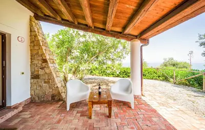 a patio with two white chairs and a table at Nice Apartment In Collesano Pa in Lascari