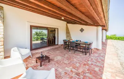 an outdoor patio with a table and chairs at Nice Apartment In Collesano Pa in Lascari