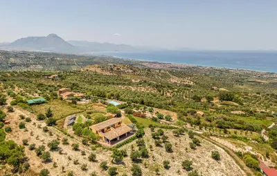 an aerial view of a house on a hill next to the ocean at Nice Apartment In Collesano Pa in Lascari