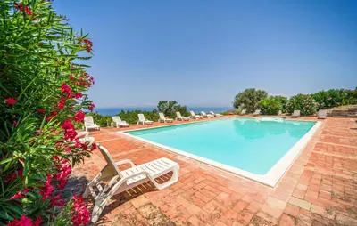 a swimming pool with lounge chairs at Nice Apartment In Collesano Pa in Lascari