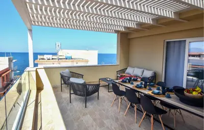 a room with a balcony with a table and chairs at Beautiful Apartment In Trappeto in Trappeto