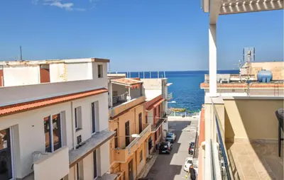 a view of the ocean from the balcony of a building at Beautiful Apartment In Trappeto in Trappeto