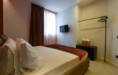 a bedroom with a bed and a window with a television at Beautiful Apartment In Trappeto in Trappeto