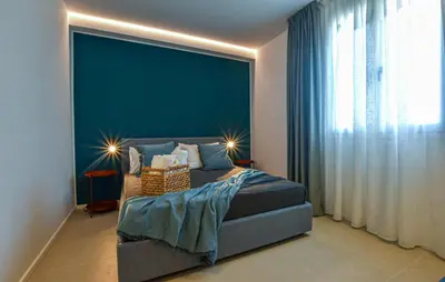 a bedroom with a bed with a blue wall at Beautiful Apartment In Trappeto in Trappeto