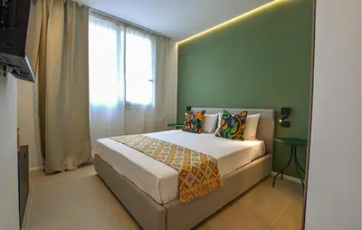 a bedroom with a bed with a green wall at Beautiful Apartment In Trappeto in Trappeto
