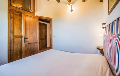 a bedroom with a bed and a wooden door at Stunning Apartment In Collesano Pa in Lascari