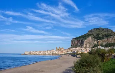 a beach with a town on a hill next to the ocean at Stunning Apartment In Collesano Pa in Lascari