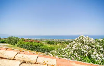 a view of the ocean from a brick wall at Stunning Apartment In Collesano Pa in Lascari