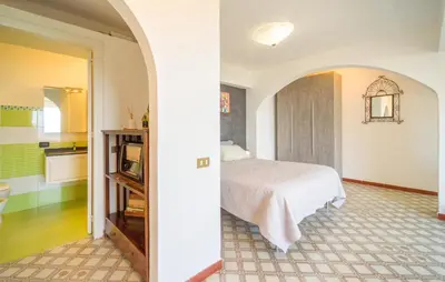 a bedroom with a bed and a kitchen at Nice Apartment In Palermo in Palermo