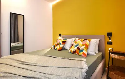 a bedroom with a bed and a yellow wall at Stunning Apartment In Trappeto in Trappeto