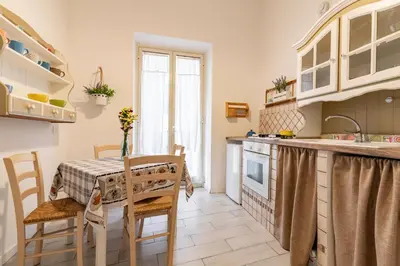 a kitchen and dining room with a table and chairs at GuestHost - Castrum Lodge - Ballarò Stylish Apartment in Palermo