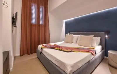 a bedroom with a large bed with a blue headboard at Stunning Apartment In Trappeto With Wifi in Trappeto