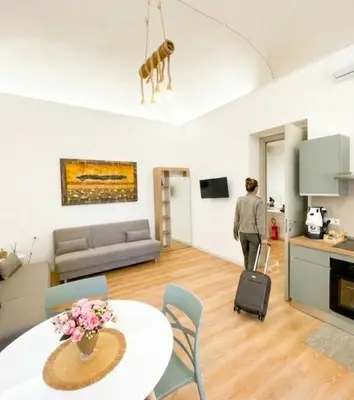 a kitchen and dining room with a table and chairs at Palermo Centro Gaale in Palermo
