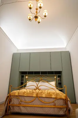 a bedroom with a bed with a chandelier at Palermo Centro Gaale in Palermo