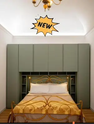 a bedroom with a bed with a new sign on the wall at Palermo Centro Gaale in Palermo