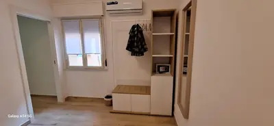 a room with a white refrigerator and a window at Nicasa, accogliente appartamento nel cuore di Palermo in Palermo