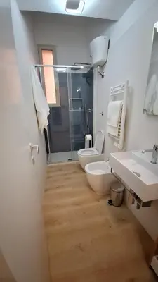 a bathroom with two sinks and a toilet and a shower at Nicasa, accogliente appartamento nel cuore di Palermo in Palermo
